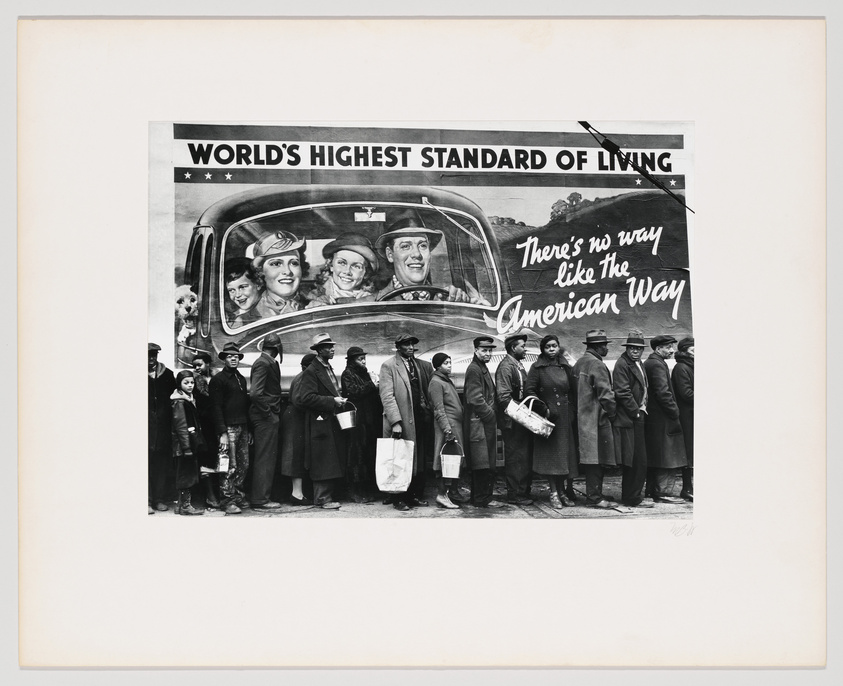 Black and white photo of people in a breadline juxtaposed with a billboard showing a happy family in a car, captioned "World's Highest Standard of Living."