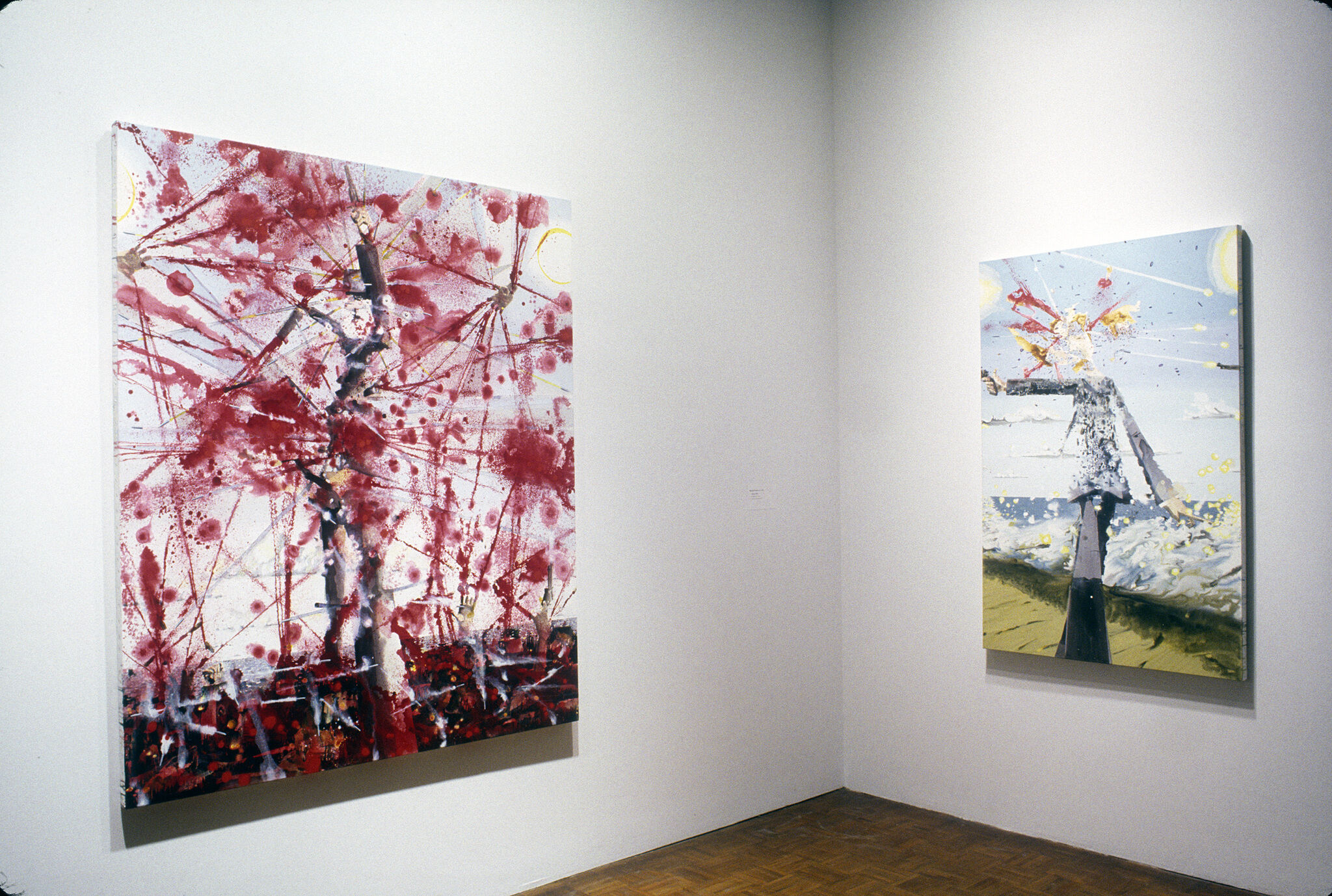 An abstract painting filled with red splatters, along with an abstract painting of a headless figure.