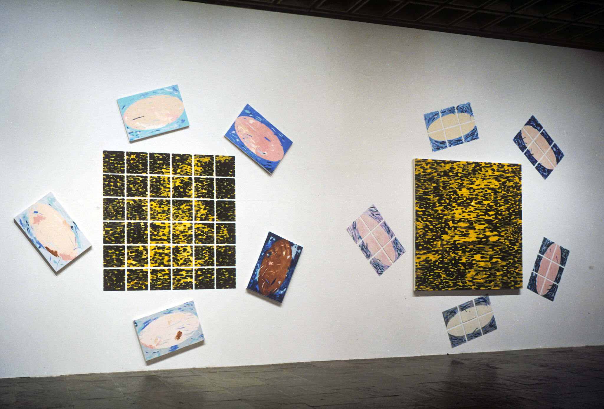 Two works of art hanging in a gallery.