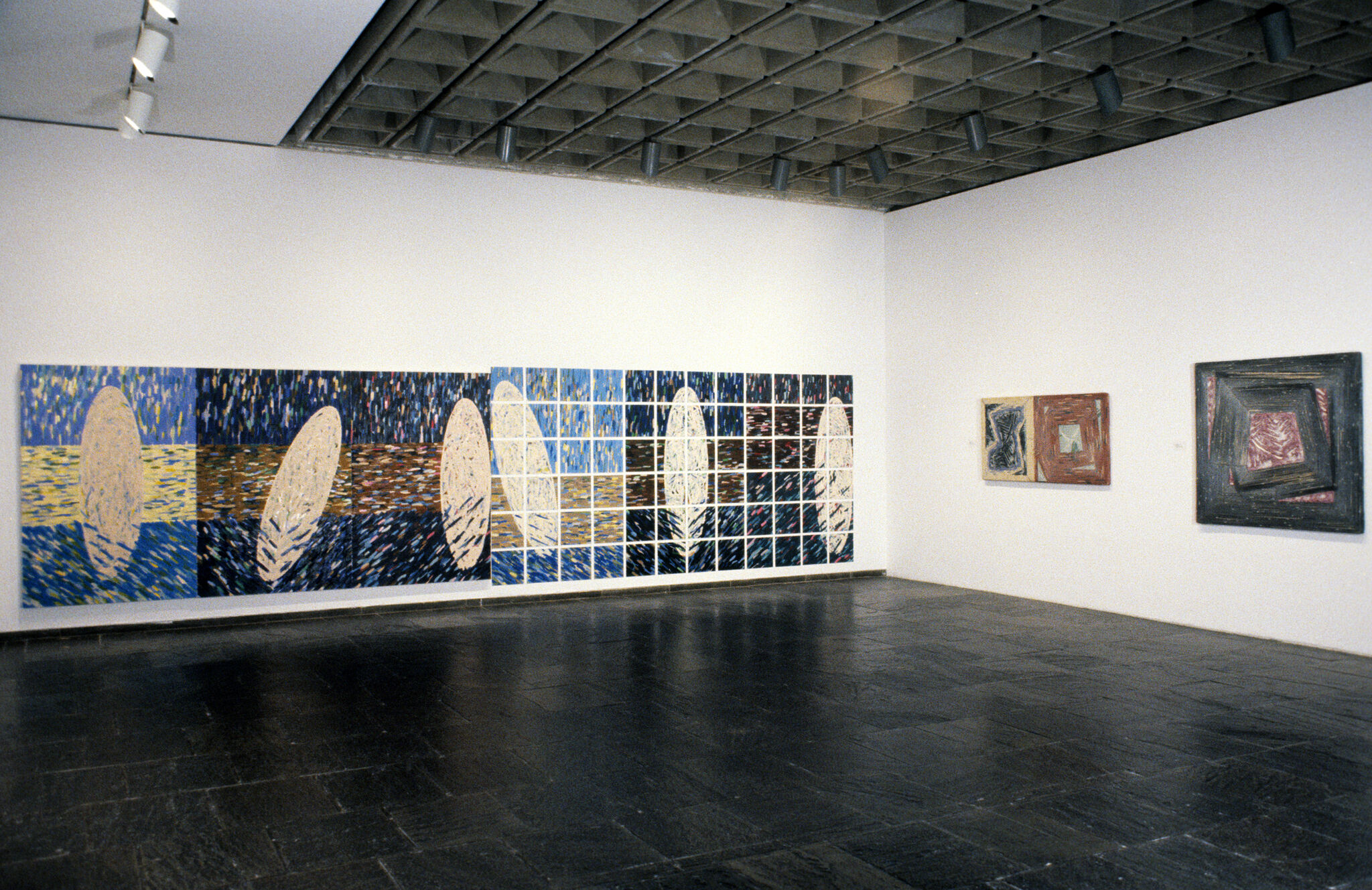 Works of art hanging in a gallery.