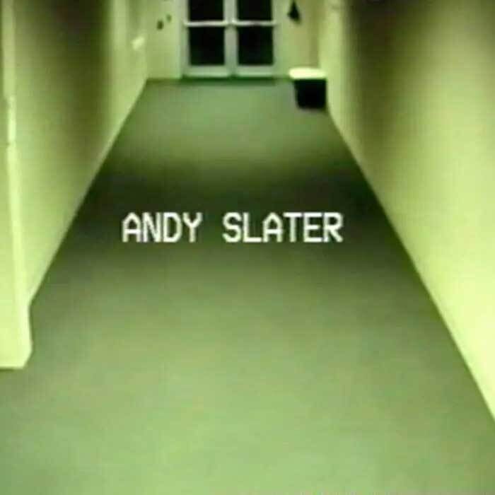 A pixelated image of a hallway bathed in yellow-green light. The words “Andy Slater” sit in the middle of the image in white capital letters. 