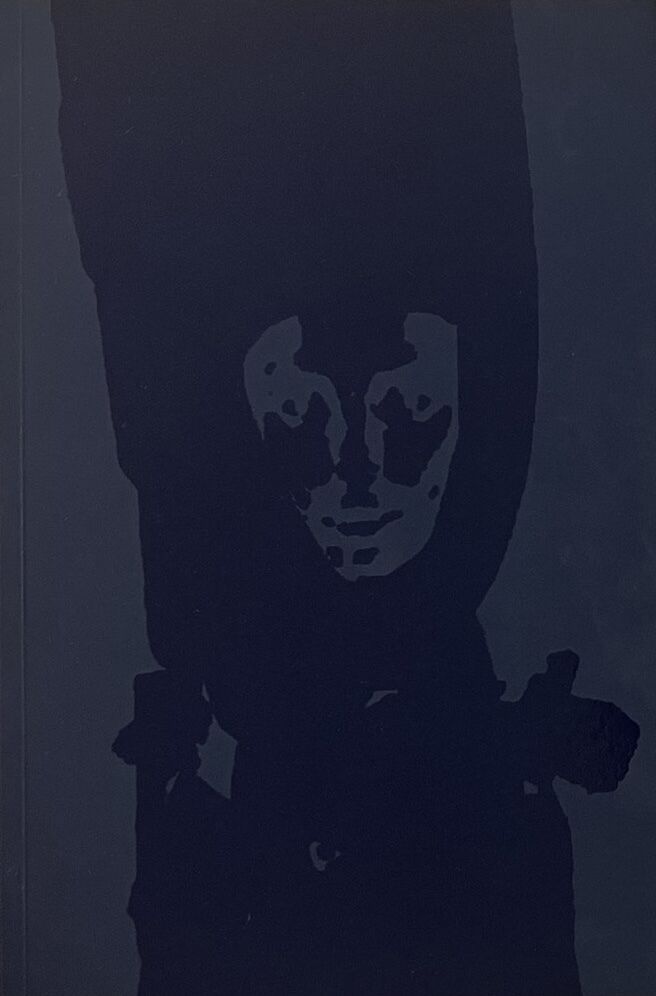 A dark blue colored background with shapes resembling a face and headdress in a deeper shade of indigo.