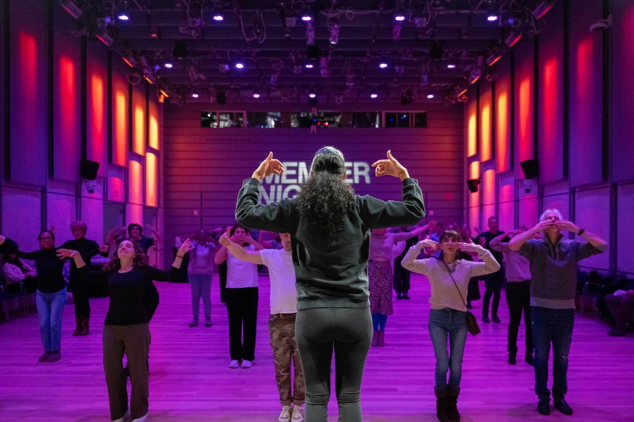 Ailey Extension instructor Lisa Johnson-Willingham on stage teaching a dance workshop to a full crowd