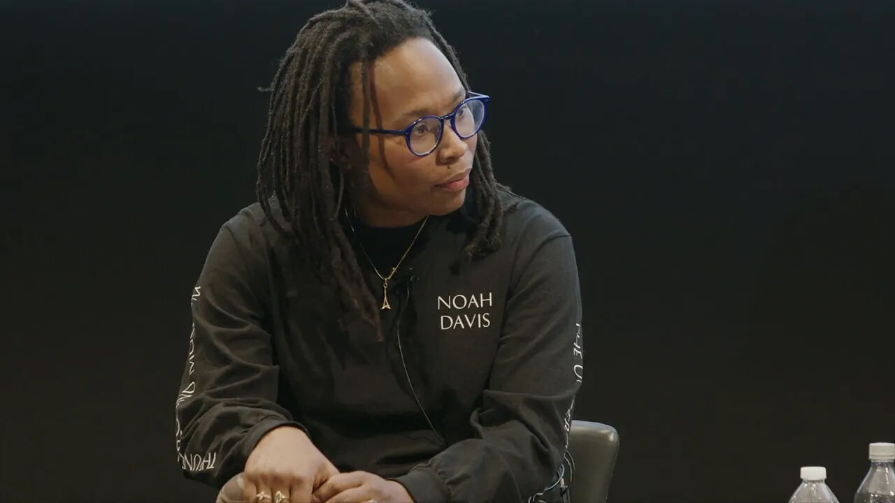 Jennifer Packer speaking on stage.