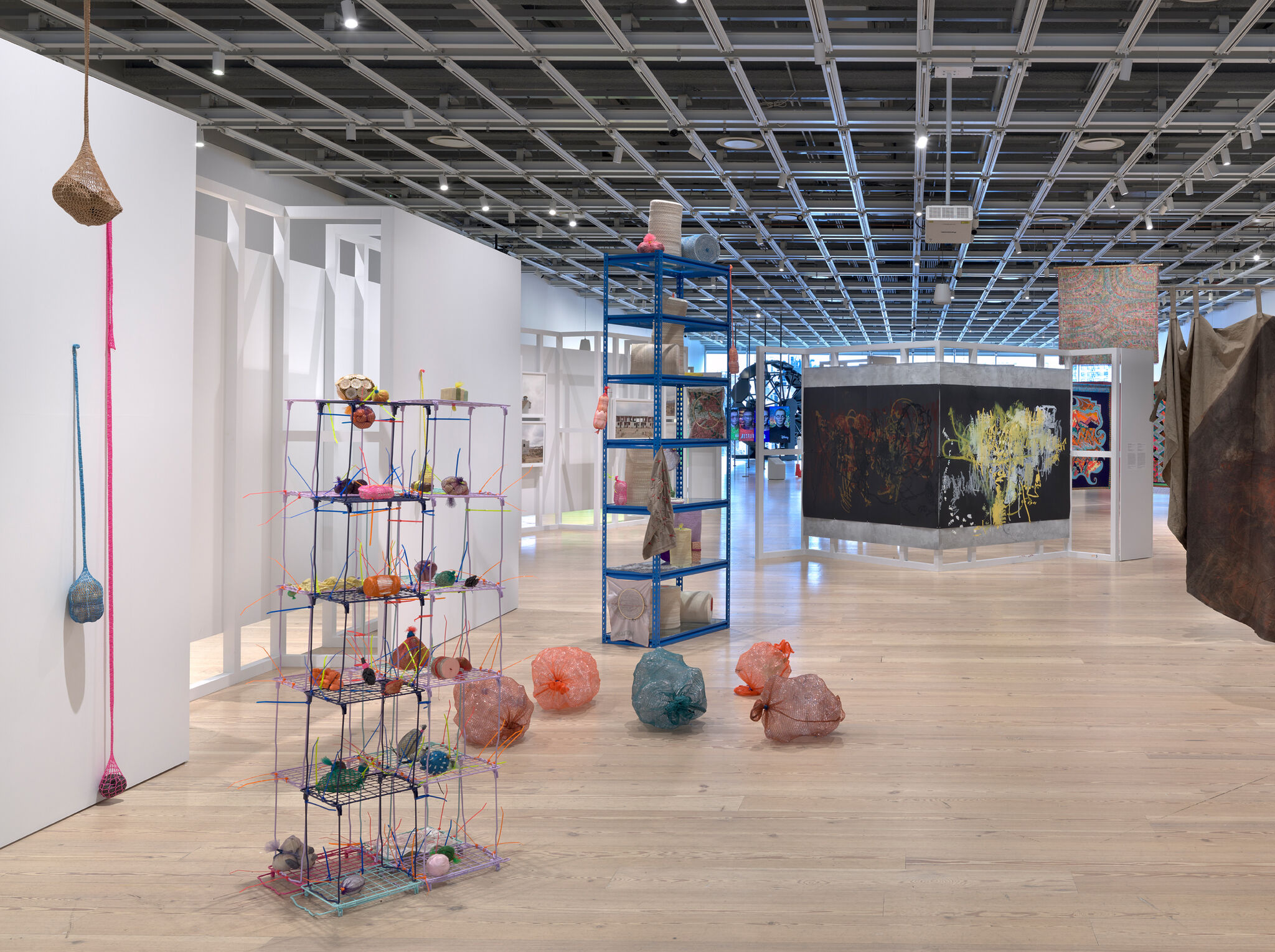 Various sized objects wrapped by different colors of mesh