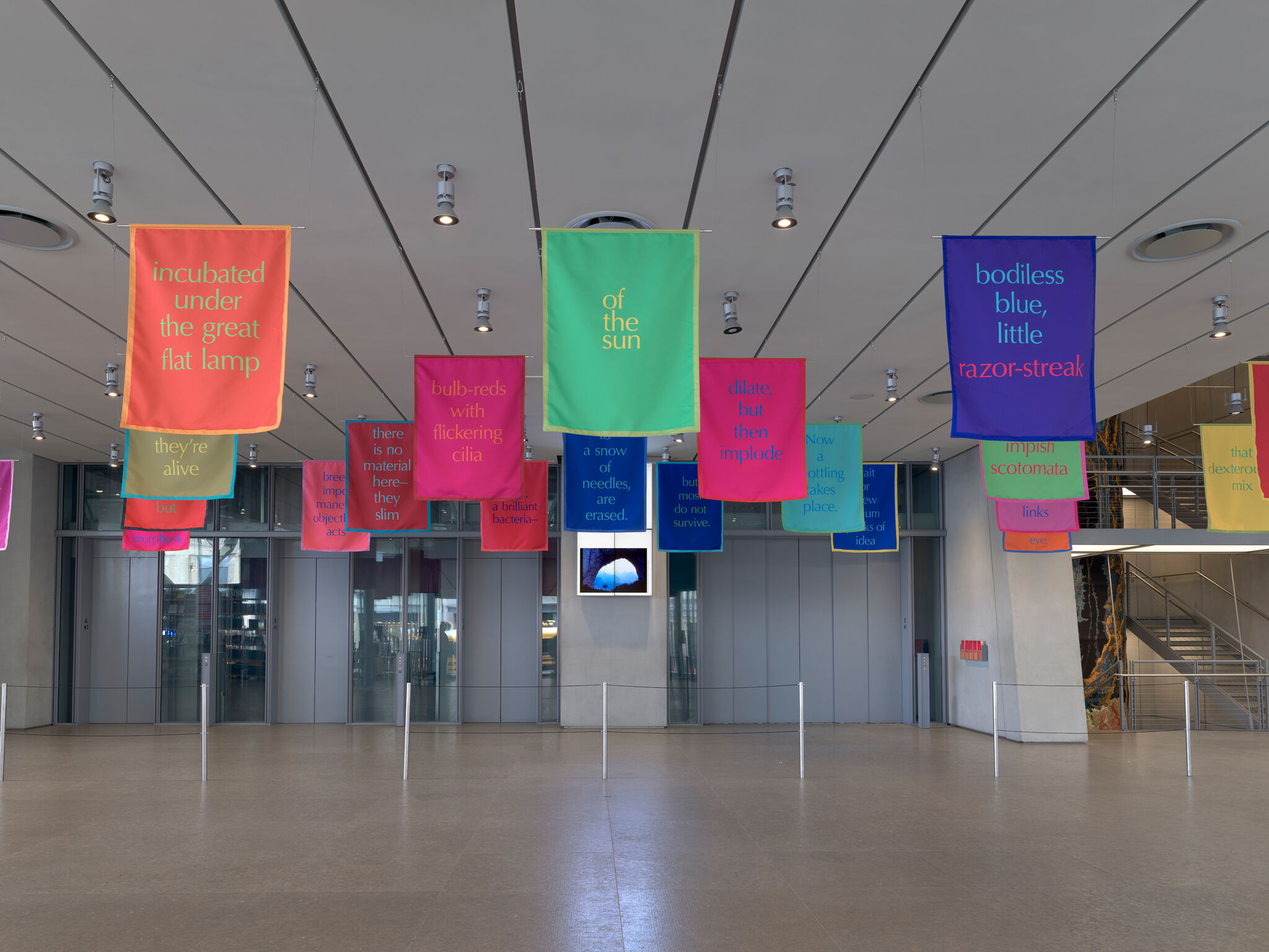 An artwork of banners hangs from the lobby ceiling. 